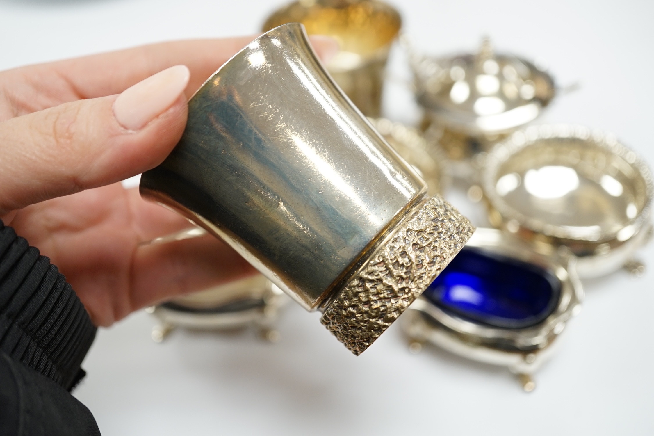 A modern pair of silver tots and five assorted silver condiments.